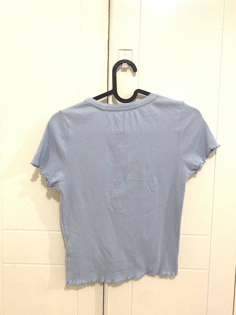 Light blue ribbed crop t-shirt size CH (Category: Shirts) located in Pasig City. Submitted by lovedbyri (Listing ID 1470688321, Image 2). Description: - Color: Light blue - Material: Sustainable soft stretchy cotton - Size: CH - Design: Ribbed texture, short sleeves, round neckline - Detail: Trendy lettuce trim hem - Styling: Great casual basic, easy to pair with jeans or shorts.