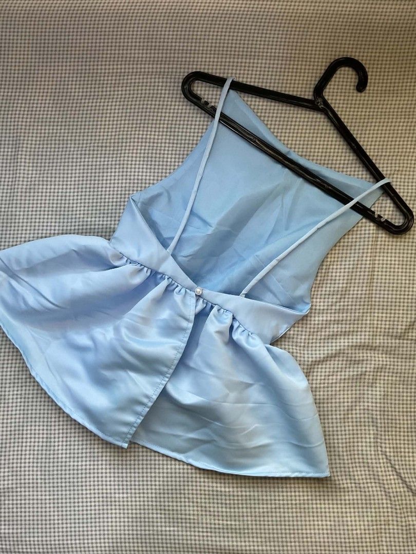 Light Blue Satin Peplum Backless Top (Category: Sleeveless) located in Marikina City. Submitted by minkookie__ (Listing ID 1470630847, Image 2). Description: BLUE PEPLUM TOP Price: 200 php + SF In great condition (New) RFS: Decluttering (Never used. Comes with a bag.) Can send more videos/pictures ! MOP/MOD: Gcash/SDD Location: Marikina City.