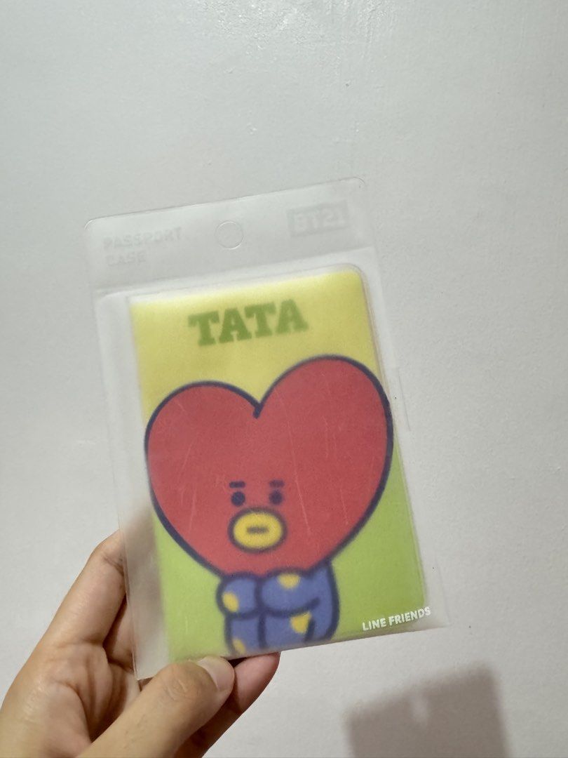LINE FRIENDS BT21 TATA Passport Case (Category: Cases & Sleeves) located in Manila. Submitted by babybear8 (Listing ID 1470678049, Image 1). Description: - 100% Authentic LINE FRIENDS BT21 merchandise featuring TATA - Vibrant yellow and green design with a cute red heart face - Brand new, sealed in original frosted plastic packaging with barcode and care labels - Made in Korea with high-quality, lightweight material - Standard passport sleeve siz