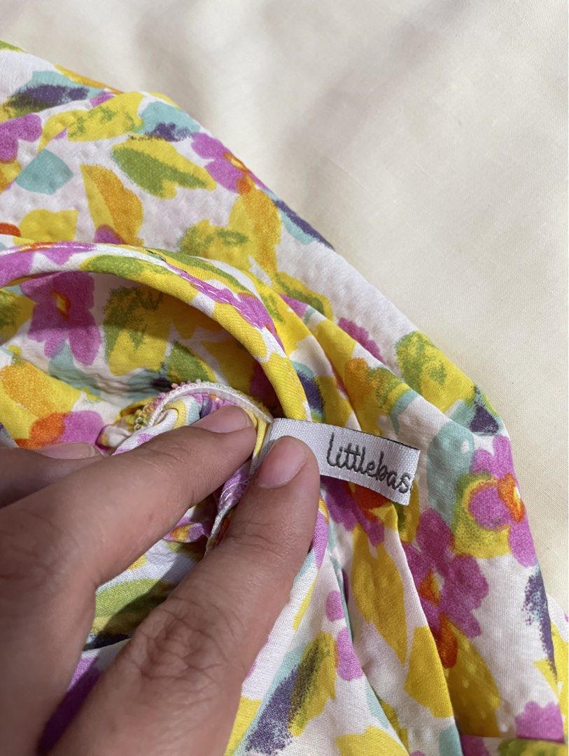 Littlebasics floral spaghetti strap dress (Category: Dresses) located in Iba. Submitted by wealtheallymari99 (Listing ID 1470715897, Image 2). Description: - Colorful floral print in yellow, purple, and green - Spaghetti straps & trendy ruffled tier design - Lightweight, breathable fabric ideal for warm weather - Casual minimalist style, great for everyday wear - Brand tag intact at the neckline.