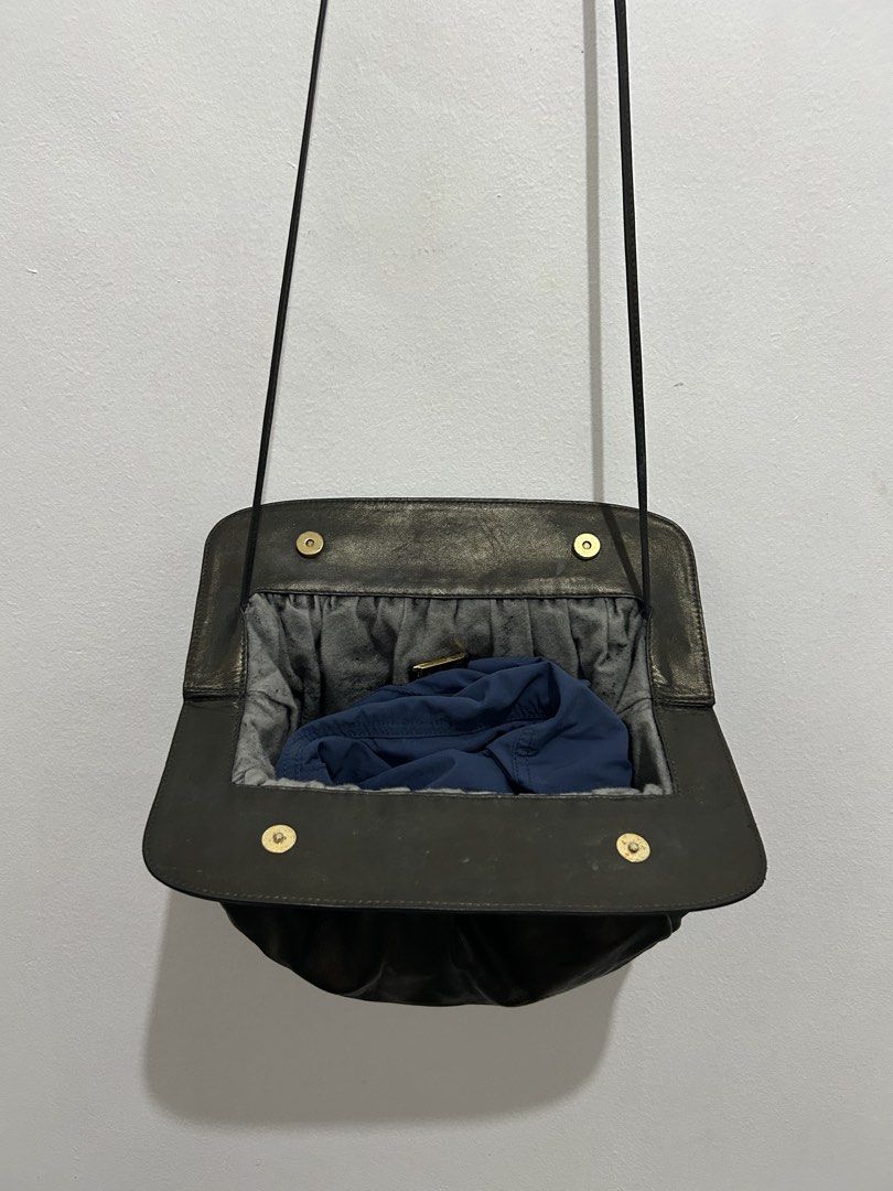 Loewe Madrid 1846 Black Leather Shoulder Bag (Category: Luxury Bags & Wallets) located in Angeles City. Submitted by cassey_phoenix (Listing ID 1470707615, Image 3). Description: - Authentic Loewe Madrid 1846 black leather shoulder bag - Soft, gathered leather body with a chic slouchy silhouette - Structured top frame featuring geometric square detailing - Secure magnetic snap closure - Slim and comfortable shoulder strap - Grey textured interior