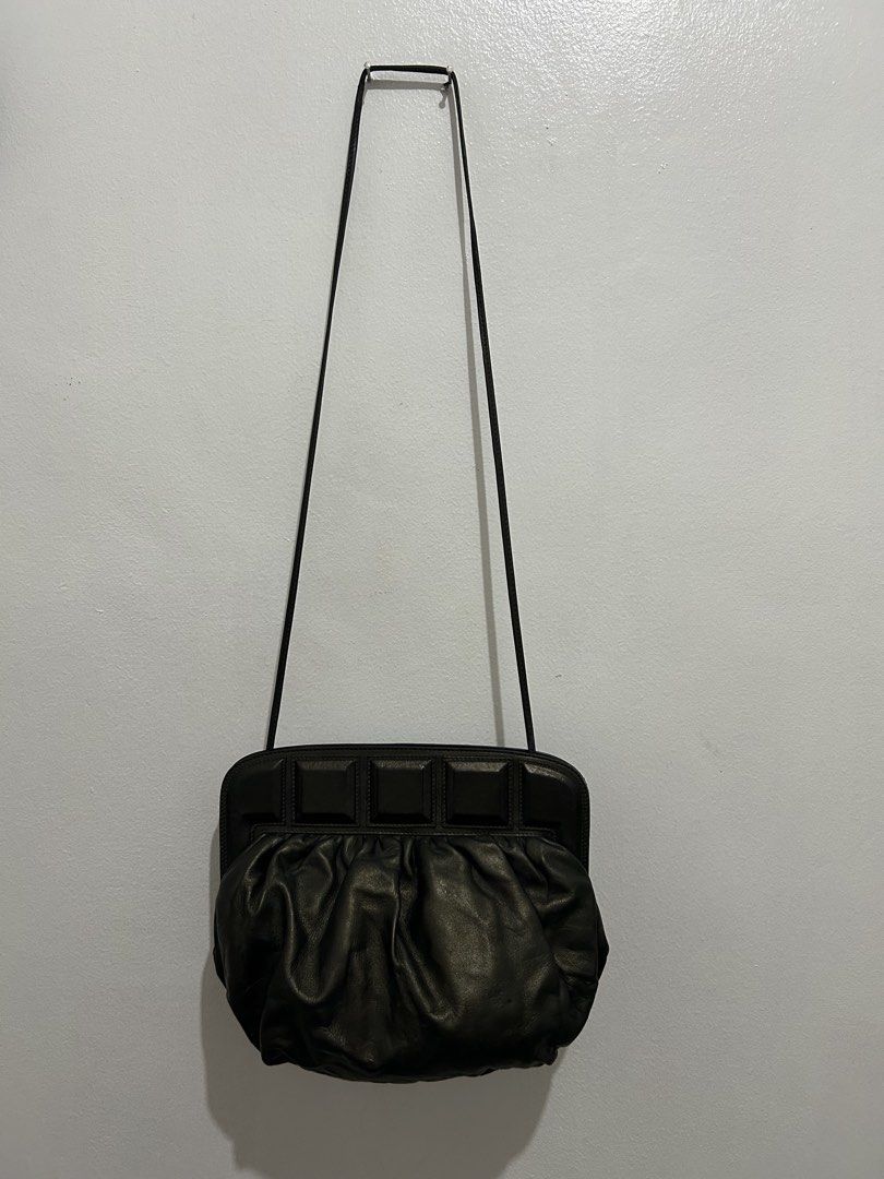 Loewe Madrid 1846 Black Leather Shoulder Bag (Category: Luxury Bags & Wallets) located in Angeles City. Submitted by cassey_phoenix (Listing ID 1470707615, Image 2). Description: - Authentic Loewe Madrid 1846 black leather shoulder bag - Soft, gathered leather body with a chic slouchy silhouette - Structured top frame featuring geometric square detailing - Secure magnetic snap closure - Slim and comfortable shoulder strap - Grey textured interior