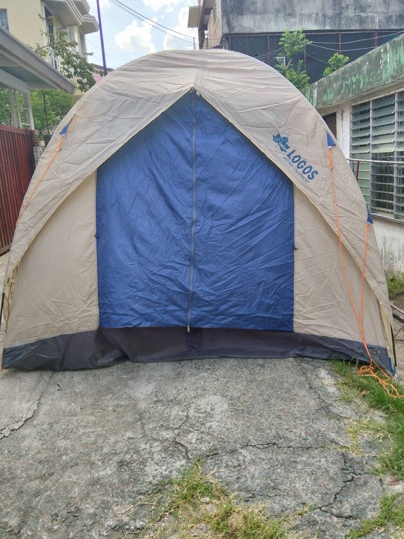 Logos Outing Equipment Multi-Room Camping Tent (Category: Hiking & Camping) located in Abucay. Submitted by cristineca20489 (Listing ID 1470615451, Image 3). Description: - Brand/Model: Logos Outing Equipment Tent - Colorway: Stylish blue and beige - Design: Large multi-room cabin style with a built-in screened porch area - Comfort & Protection: Mesh windows and zippered doors to keep bugs out - Setup: Includes sturdy poles and guy lines for reli