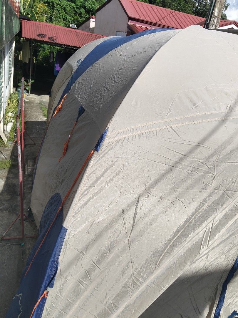 Logos Outing Equipment Multi-Room Camping Tent (Category: Hiking & Camping) located in Abucay. Submitted by cristineca20489 (Listing ID 1470615451, Image 2). Description: - Brand/Model: Logos Outing Equipment Tent - Colorway: Stylish blue and beige - Design: Large multi-room cabin style with a built-in screened porch area - Comfort & Protection: Mesh windows and zippered doors to keep bugs out - Setup: Includes sturdy poles and guy lines for reli