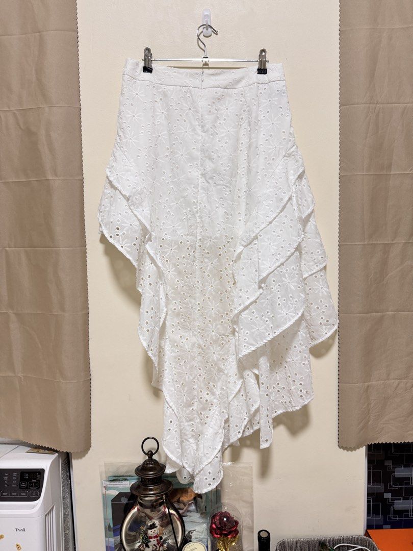 Long Back Skirt (Category: Skirts) located in Manila. Submitted by seayouncey (Listing ID 1470672691, Image 2). Description: Never used Size 30 to 31 inches - Color: Classic White - Style: High-low hem with tiered ruffles and flowy silhouette - Details: Beautiful floral embroidery cutouts and lightweight fabric - Fit: Fitted waistband with a secure back zipper closure - Perfect for: Sunny weather, beach trips, and casual outings.