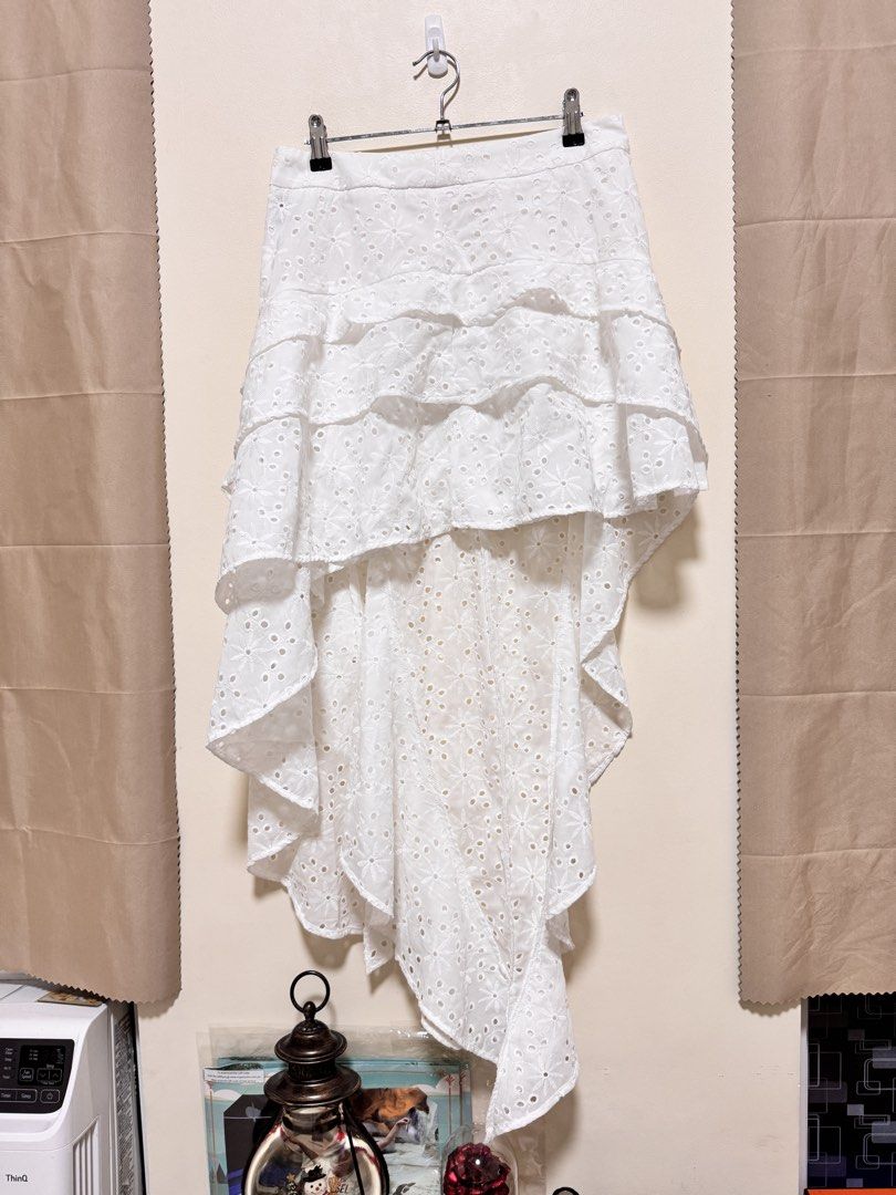 Long Back Skirt (Category: Skirts) located in Manila. Submitted by seayouncey (Listing ID 1470672691, Image 1). Description: Never used Size 30 to 31 inches - Color: Classic White - Style: High-low hem with tiered ruffles and flowy silhouette - Details: Beautiful floral embroidery cutouts and lightweight fabric - Fit: Fitted waistband with a secure back zipper closure - Perfect for: Sunny weather, beach trips, and casual outings.