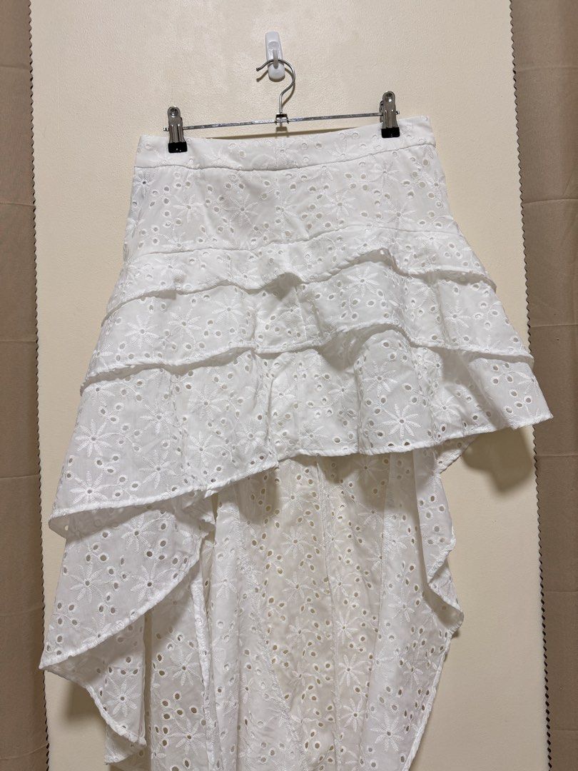 Long Back Skirt (Category: Skirts) located in Manila. Submitted by seayouncey (Listing ID 1470672691, Image 3). Description: Never used Size 30 to 31 inches - Color: Classic White - Style: High-low hem with tiered ruffles and flowy silhouette - Details: Beautiful floral embroidery cutouts and lightweight fabric - Fit: Fitted waistband with a secure back zipper closure - Perfect for: Sunny weather, beach trips, and casual outings.