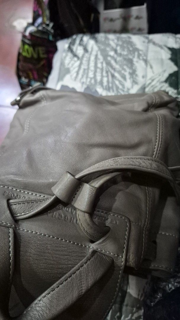 Longchamp Le Pliage Cuir Leather Backpack Grey (Category: Looking For) located in Baguio. Submitted by jhaz_bags (Listing ID 1470679641, Image 2). Description: - Brand: Longchamp - Material: Soft grey leather (Made in Morocco) - Closure: Flap top with snap button and drawstring - Straps: Adjustable leather straps with a top grab handle - Size: Compact, ideal for daily essentials - Condition: Pre-loved with visible wear on the front flap and edges