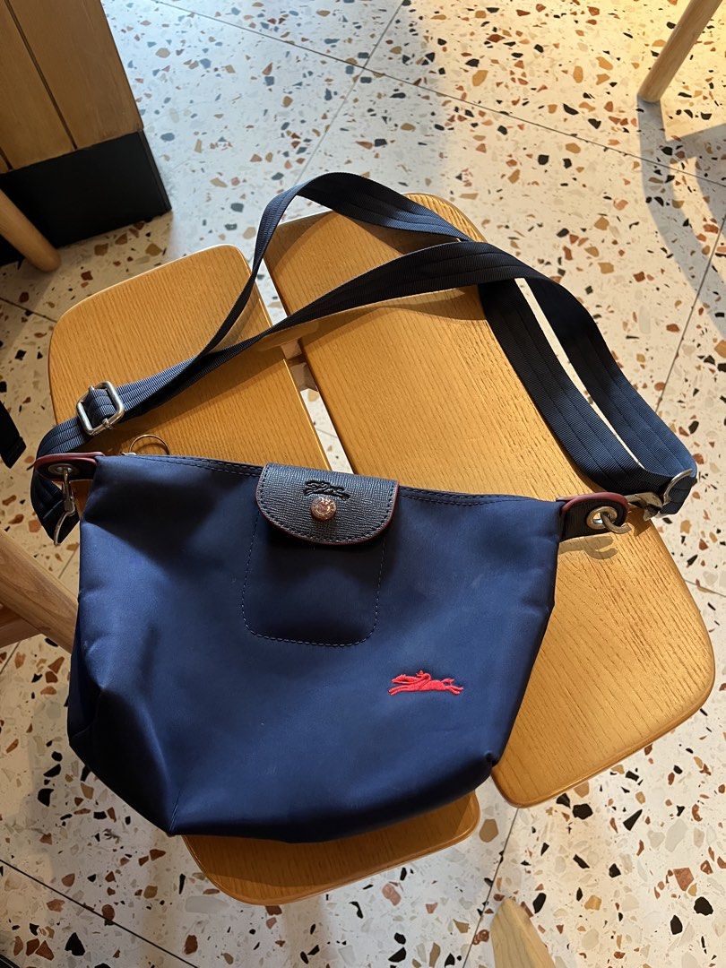 LONGCHAMP Mini Le Pliage (Without handle) (Category: Cross-body Bags) located in Quezon City. Submitted by ynfvilla (Listing ID 1470626031, Image 1). Description: Authentic Longchamp Le Pliage in navy blue — Lightweight; water-resistant material — Spacious interior with zip closure — Great everyday or travel bag Honest Issue: Gently used but lock of strap snapped off / O-ring fell out RFS: decluttering Loc: Katipunan, QC — NEGOTIABLE ‼️ dm me you
