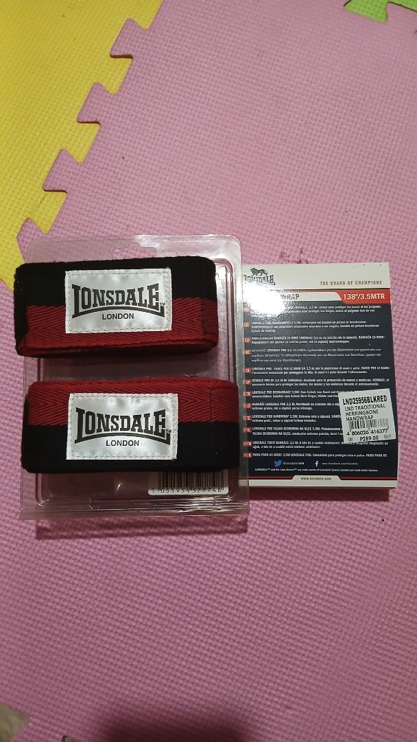 Lonsdale Pro Hand Wrap 3.5M Traditional Herringbone (Category: Combat Sports) located in Manila. Submitted by oddfire.10fe9b (Listing ID 1470575463, Image 1). Description: - Brand: Lonsdale Pro - Color: Black and Red - Condition: Brand new, unopened in original packaging - Length: Standard 3.5 meters / 138 inches - Material: Traditional herringbone style for durability and comfort - Closure: Secure hook and loop fastening system.