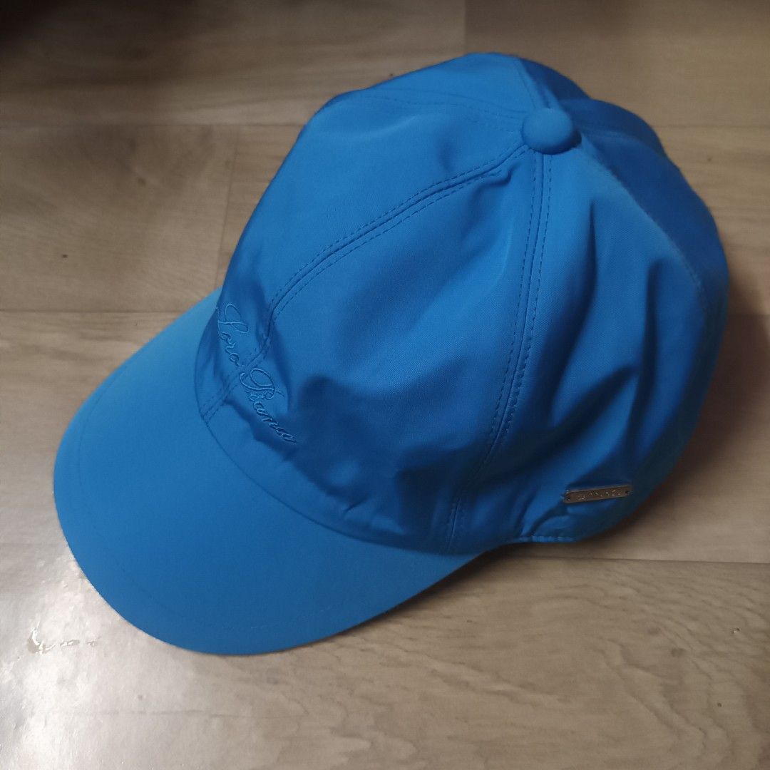 Loro Piana SS Cap Azure Blue (Category: Caps & Hats) located in Manila. Submitted by itsnik444 (Listing ID 1470601746, Image 3). Description: - Authentic Loro Piana cap made in Italy - Color: Bright blue - Storm System technology for waterproof and wind-resistant weather protection - Embroidered Loro Piana script logo on the side panel - Small metal brand plaque near the back - Classic plaid interior lining with a brown sweatband - Elastic back c