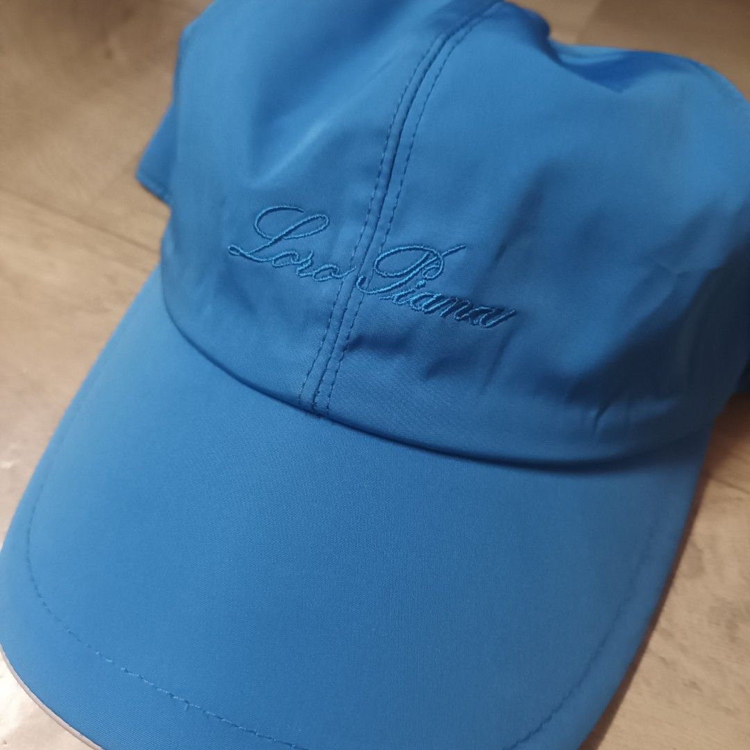 Loro Piana SS Cap Azure Blue (Category: Caps & Hats) located in Manila. Submitted by itsnik444 (Listing ID 1470601746, Image 2). Description: - Authentic Loro Piana cap made in Italy - Color: Bright blue - Storm System technology for waterproof and wind-resistant weather protection - Embroidered Loro Piana script logo on the side panel - Small metal brand plaque near the back - Classic plaid interior lining with a brown sweatband - Elastic back c
