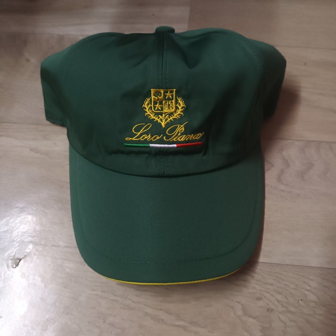 Loro Piana SS Cap Green (Category: Caps & Hats) located in Manila. Submitted by itsnik444 (Listing ID 1470602688, Image 1). Description: - Brand: Loro Piana (Made in Italy) - Color: Green exterior with a vibrant yellow brim underside - Details: Embroidered logo crest and Italian flag stripe on the exterior - Interior: Stylish plaid lining with official black Storm System brand tag - Fit: Comfortable elastic back strap for an adjustable fit - Cond
