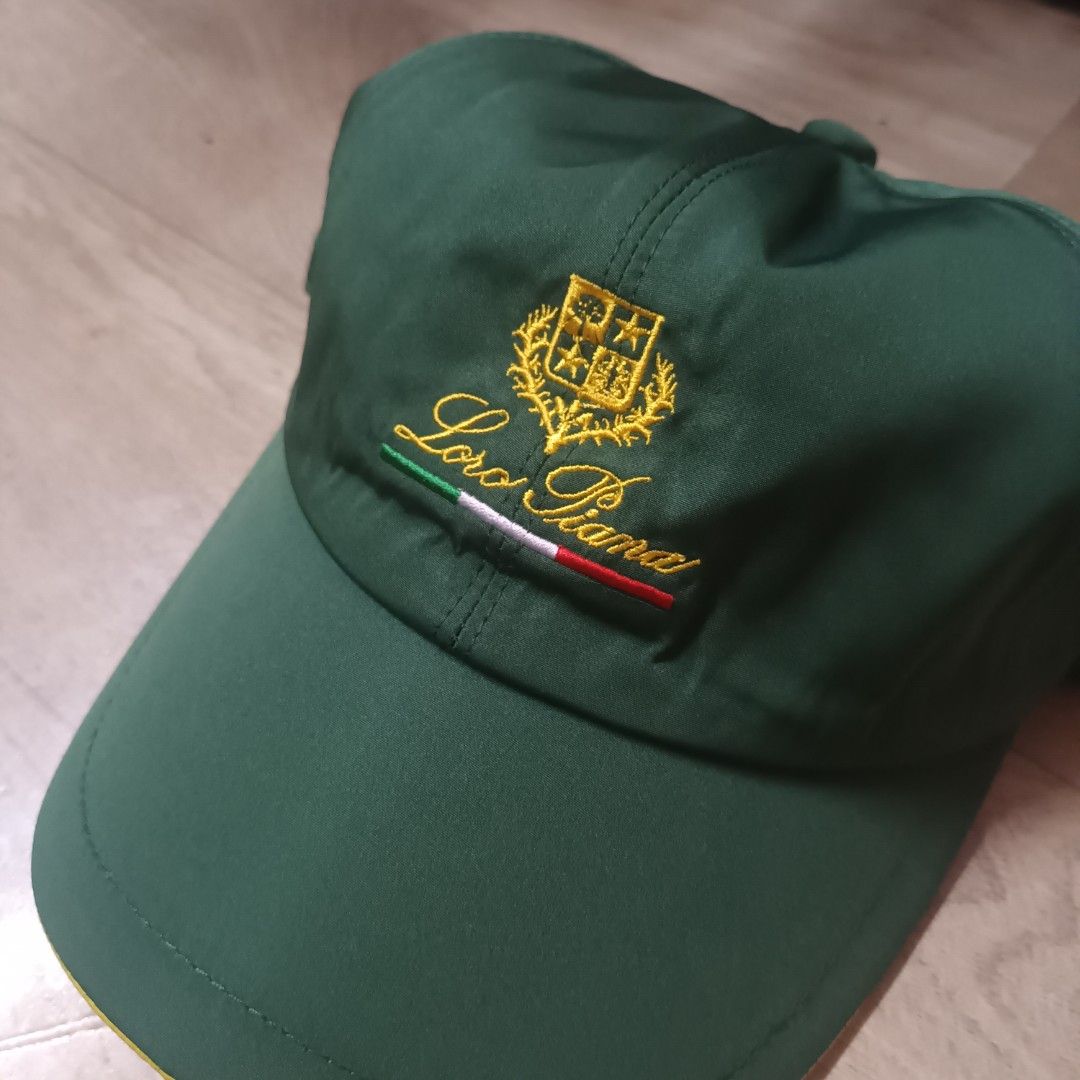 Loro Piana SS Cap Green (Category: Caps & Hats) located in Manila. Submitted by itsnik444 (Listing ID 1470602688, Image 2). Description: - Brand: Loro Piana (Made in Italy) - Color: Green exterior with a vibrant yellow brim underside - Details: Embroidered logo crest and Italian flag stripe on the exterior - Interior: Stylish plaid lining with official black Storm System brand tag - Fit: Comfortable elastic back strap for an adjustable fit - Cond