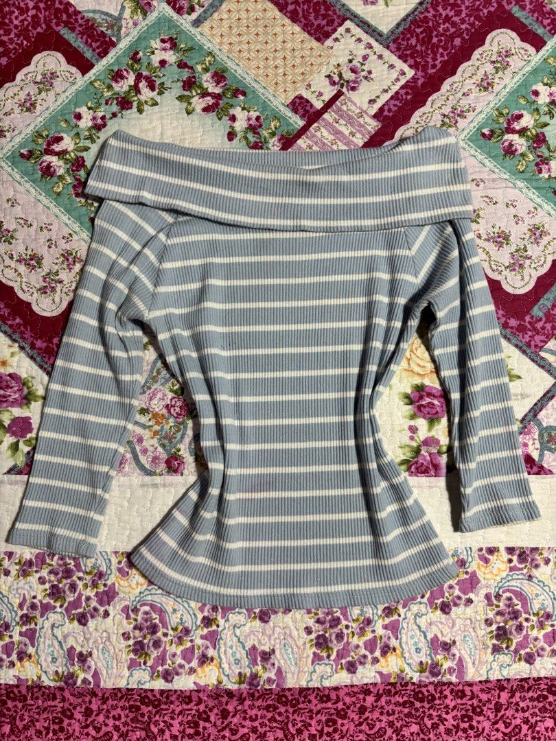 Blue striped off shoulder (Category: Blouses) located in Sual. Submitted by cinnamorol_lovar (Listing ID 1470565951, Image 1). Description: - Top 1: Light blue with white stripes, trendy foldover off-the-shoulder neckline, comfy ribbed knit fabric, and long sleeves .