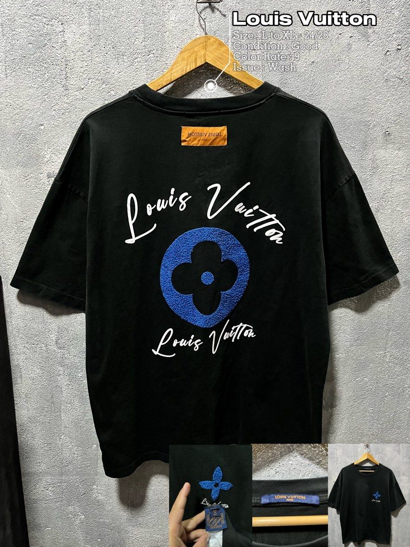 Louis Vuitton Black T-Shirt with Blue Flower Patch (Category: Tshirts & Polo Shirts ) located in Lubao. Submitted by genjithrifted (Listing ID 1470590846, Image 1). Description: - Brand: Louis Vuitton - Color: Black - Size: Fits L to XL (Approx. 24" x 28" measurements) - Fit: Relaxed fit - Details: Large white script branding with textured blue Monogram flower patch on the back - Chest: Small blue flower embroidery on front left - Accent: Orange 