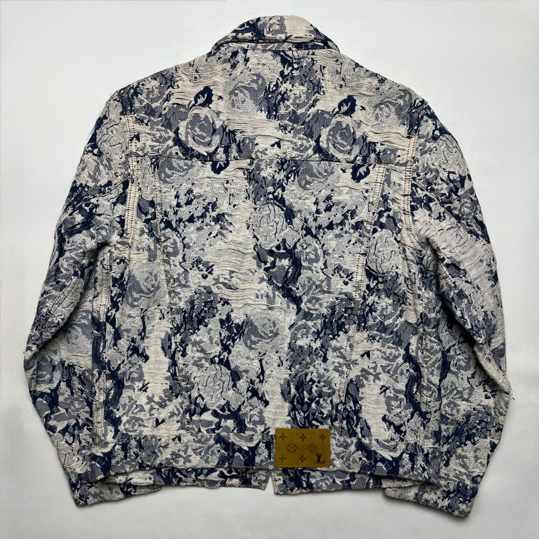 Louis Vuitton Erosion Denim Jacket (Category: Coats, Jackets and Outerwear) located in Caloocan City. Submitted by achilles_grails (Listing ID 1470579451, Image 2). Description: - Style: Blue and white patterned denim jacket with a classic collar and structured fit - Details: Front button closures with engraved logos and functional chest pockets - Branding: Suede LV branded patch on the back lower hem - Material: Heavy, intricate textured woven f