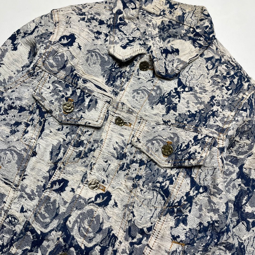 Louis Vuitton Erosion Denim Jacket (Category: Coats, Jackets and Outerwear) located in Caloocan City. Submitted by achilles_grails (Listing ID 1470579451, Image 3). Description: - Style: Blue and white patterned denim jacket with a classic collar and structured fit - Details: Front button closures with engraved logos and functional chest pockets - Branding: Suede LV branded patch on the back lower hem - Material: Heavy, intricate textured woven f
