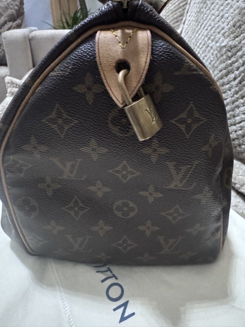Louis Vuitton Monogram Canvas Handbag 35 (Category: Luxury Bags & Wallets) located in Quezon City. Submitted by itsnotmeitsu (Listing ID 1470616250, Image 2). Description: - Authentic Louis Vuitton monogram canvas handbag - Clean canvas body with natural leather patina on vachetta trim and handles - Features handles wrapped in a chic patterned silk twilly scarf - Includes matching padlock with keys and original dust bag, LegitGrails - Ships secur
