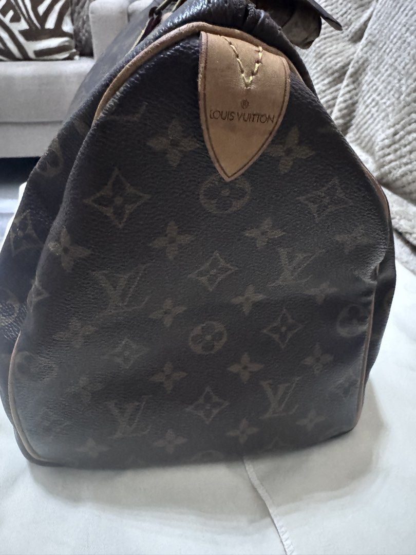 Louis Vuitton Monogram Canvas Handbag 35 (Category: Luxury Bags & Wallets) located in Quezon City. Submitted by itsnotmeitsu (Listing ID 1470616250, Image 3). Description: - Authentic Louis Vuitton monogram canvas handbag - Clean canvas body with natural leather patina on vachetta trim and handles - Features handles wrapped in a chic patterned silk twilly scarf - Includes matching padlock with keys and original dust bag, LegitGrails - Ships secur
