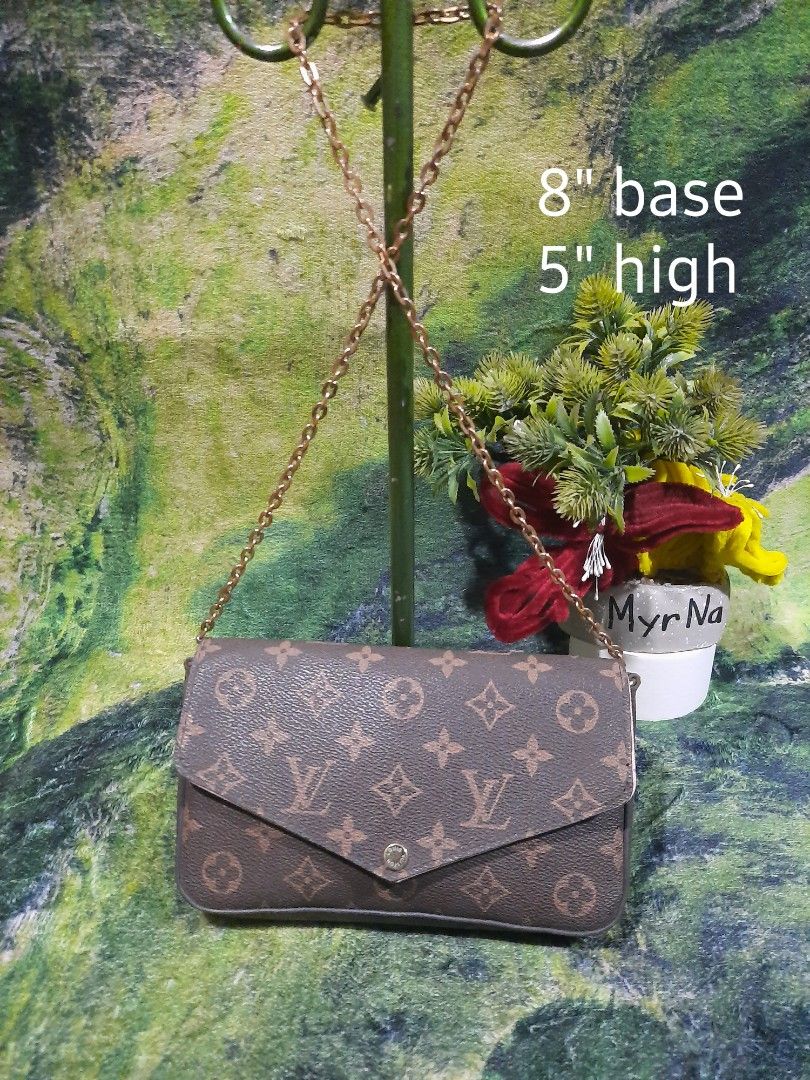 Louis Vuitton Monogram Chain Crossbody Bag (Category: Luxury Bags & Wallets) located in Baguio. Submitted by klayblakeb87803 (Listing ID 1470628294, Image 1). Description: - Style: Crossbody bag with envelope flap and snap button closure - Material: Classic brown monogram canvas with gold-tone chain strap - Interior: Pink fabric lining with a convenient slip pocket and Louis Vuitton Paris tag - Dimensions: 8 inches (base) x 5 inches (height) - Co
