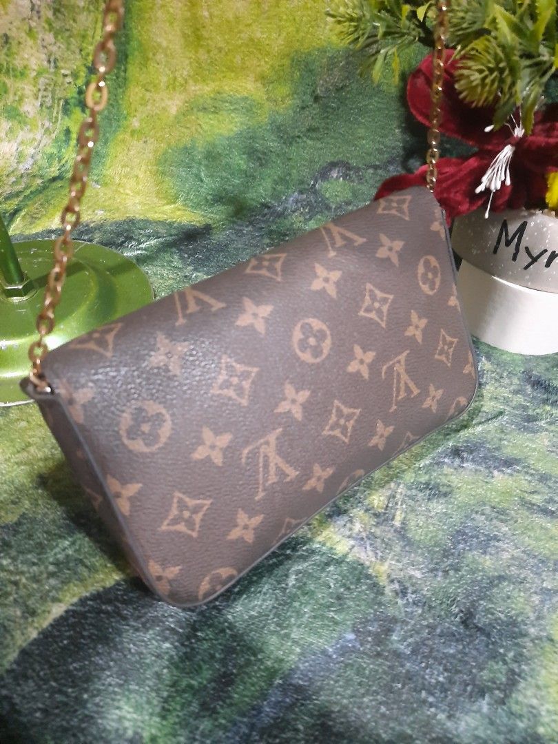 Louis Vuitton Monogram Chain Crossbody Bag (Category: Luxury Bags & Wallets) located in Baguio. Submitted by klayblakeb87803 (Listing ID 1470628294, Image 2). Description: - Style: Crossbody bag with envelope flap and snap button closure - Material: Classic brown monogram canvas with gold-tone chain strap - Interior: Pink fabric lining with a convenient slip pocket and Louis Vuitton Paris tag - Dimensions: 8 inches (base) x 5 inches (height) - Co