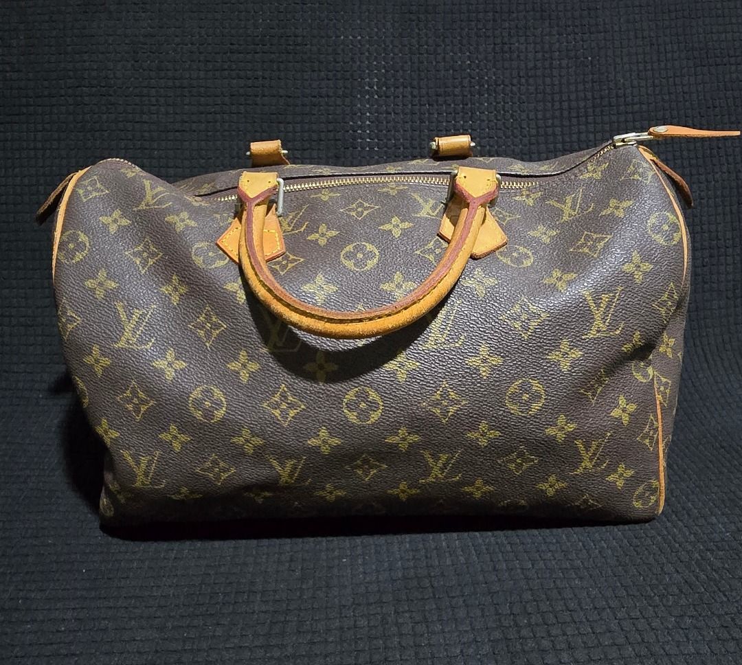 Louis Vuitton Monogram Speedy Handbag - Negotiable!!! (Category: Luxury Bags & Wallets) located in Manila. Submitted by axelyuna.27 (Listing ID 1470571440, Image 1). Description: Classic Louis Vuitton monogram canvas handbag. Brown with gold-tone hardware and vachetta leather trim. Dual rolled leather top handles. Top zip closure. Spacious interior for daily essentials. Iconic vintage travel bag style. Natural patina on leather handles and trim. 
