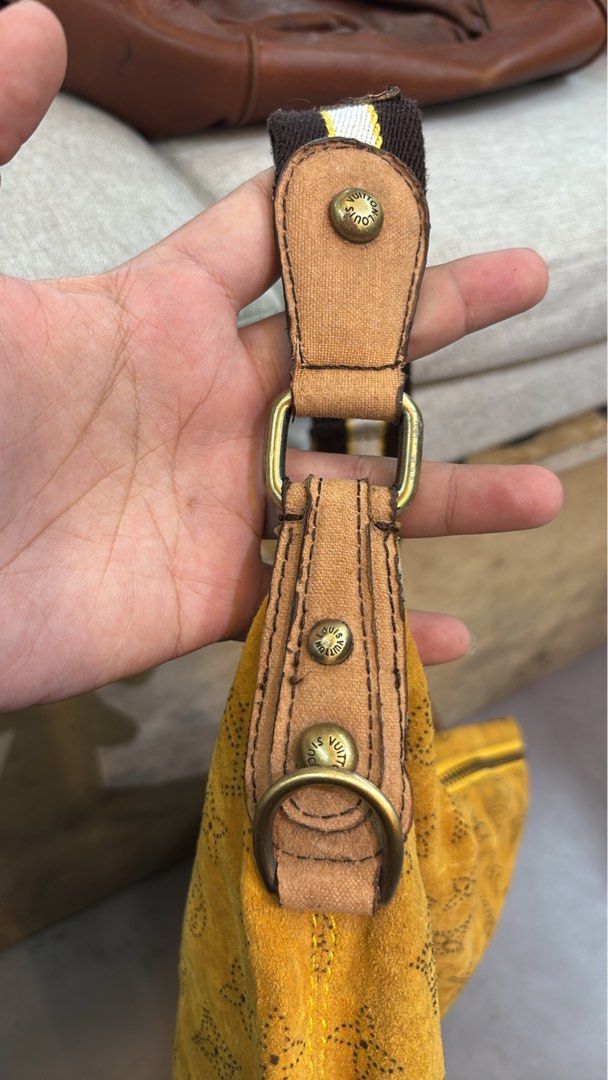 Louis Vuitton Monogram Suede Yellow Shoulder Bag (Category: Luxury Bags & Wallets) located in Caloocan City. Submitted by neweagle-424b (Listing ID 1470696254, Image 3). Description: missing serial code - Brand: Louis Vuitton - Material: Yellow suede with Monogram print and brown monogram fabric lining - Strap: Brown and white adjustable fabric strap with brass hardware - Closure: Top zip with LV branded pull tab (shows slight wear at the ends) -