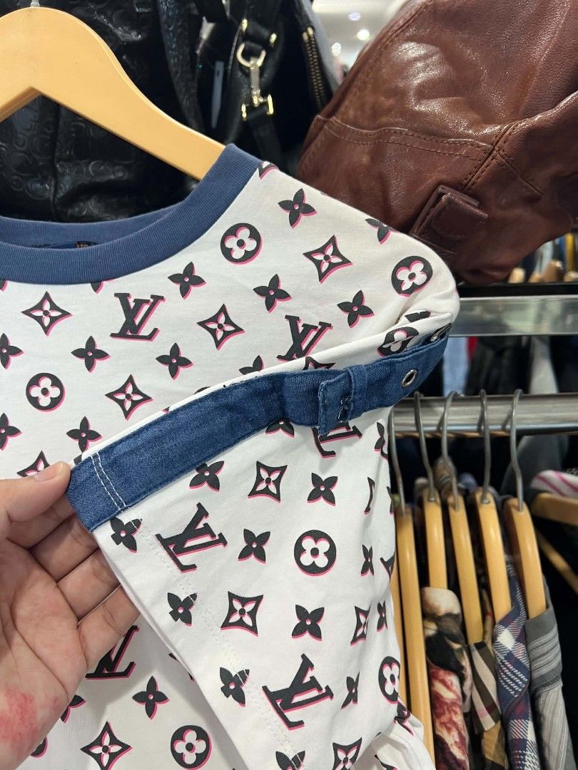 Louis Vuitton Monogram White Pink Tee Shirt (Category: Shirts) located in Urdaneta. Submitted by jayceegarage (Listing ID 1470690292, Image 2). Description: - Designer-style white t-shirt with iconic Louis Vuitton monogram print - Eye-catching pink and black details with a contrast blue rib knit crew neckline - Unique short sleeves finished with trendy denim fabric straps - Size: Large (tag inside collar) - Origin: Made in Italy - Care Instructio