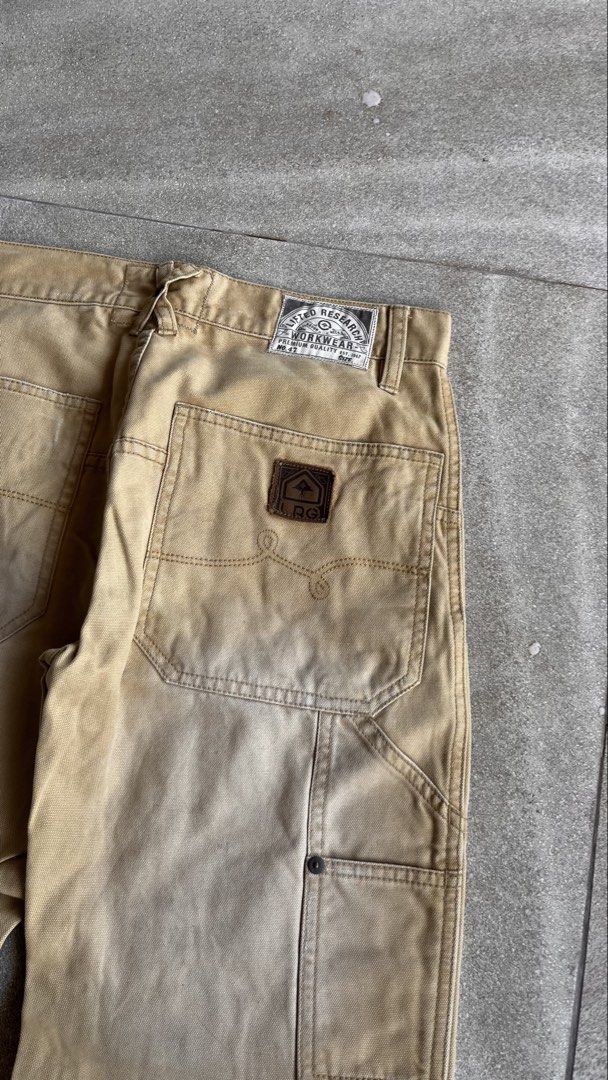 LRG Lifted Research Group Workwear Cargo Pants (Category: Jeans) located in Cabuyao City. Submitted by bulandos (Listing ID 1470656940, Image 3). Description: - Brand: LRG (Lifted Research Group) - Style: Workwear cargo pants / Relaxed carpenter fit - Color: Tan with natural fade - Material: Heavy-duty canvas - Features: Double knee panels, utility pockets, tool loop, and branded rear patch - Condition: Distressed details near the front pocket, g