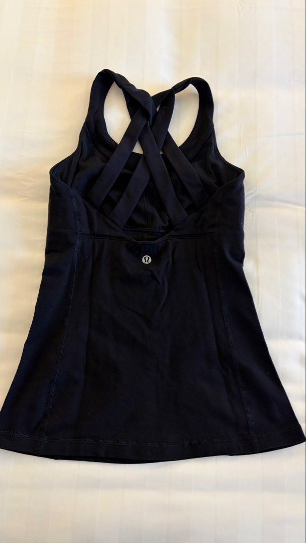 Lululemon Black Tank Top with Strappy Back (Category: Sleeveless) located in Manila. Submitted by letmeclean (Listing ID 1470668178, Image 1). Description: - Brand: Lululemon - Color: Classic Black - Design: Scoop neck with a striking multi-strap crisscross back - Details: Signature silver omega logo on the back hem - Support: Built-in shelf bra with front and back contour seaming - Fabric: Stretchy, breathable, and moisture-wicking performance m