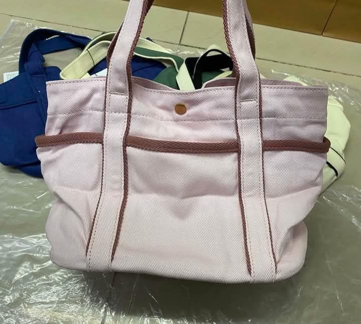 Lululemon Canvas Mini Tote Bag 31x21cm (Category: Tote Bags) located in Del Monte. Submitted by balanijoan70708 (Listing ID 1470670730, Image 3). Description: - Brand new with tags attached - Dimensions: 31x21cm with a 6.5L capacity - Features iconic round logo patch on the front - Secure snap button closure and dual top handles - Practical exterior pockets on both sides plus an interior slip pocket - Available in multiple gorgeous colors: pink, 