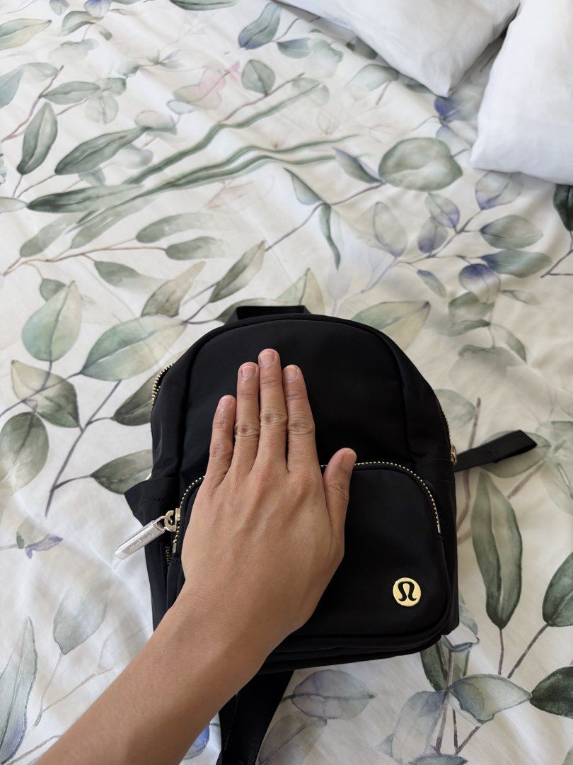 Lululemon Mini Nylon Backpack Black Gold Hardware (Category: Backpacks) located in Dagupan City. Submitted by myclosetcloud (Listing ID 1470567186, Image 3). Description: - Authentic Lululemon black nylon backpack - Elegant gold-tone zippers and hardware - Compact size ideal for daily errands or light travel - Front zip pocket and interior mesh storage for easy organization - Adjustable webbing shoulder straps and top grab handle - Signature Lulu