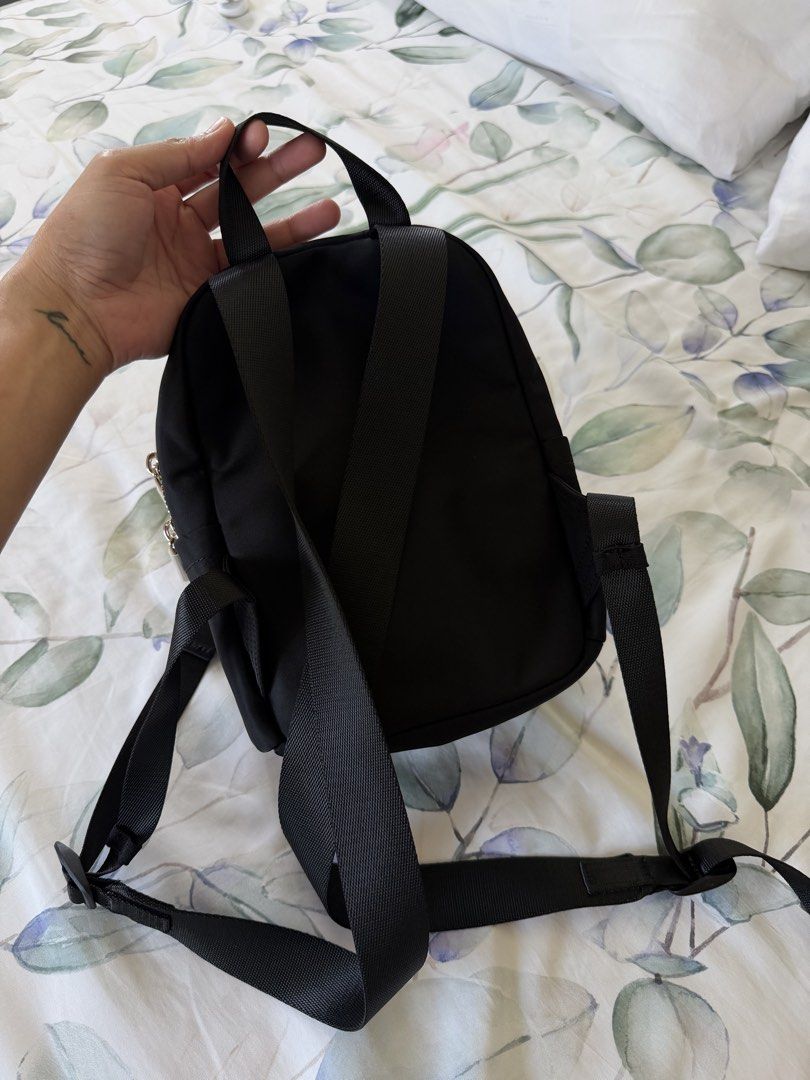 Lululemon Mini Nylon Backpack Black Gold Hardware (Category: Backpacks) located in Dagupan City. Submitted by myclosetcloud (Listing ID 1470567186, Image 2). Description: - Authentic Lululemon black nylon backpack - Elegant gold-tone zippers and hardware - Compact size ideal for daily errands or light travel - Front zip pocket and interior mesh storage for easy organization - Adjustable webbing shoulder straps and top grab handle - Signature Lulu