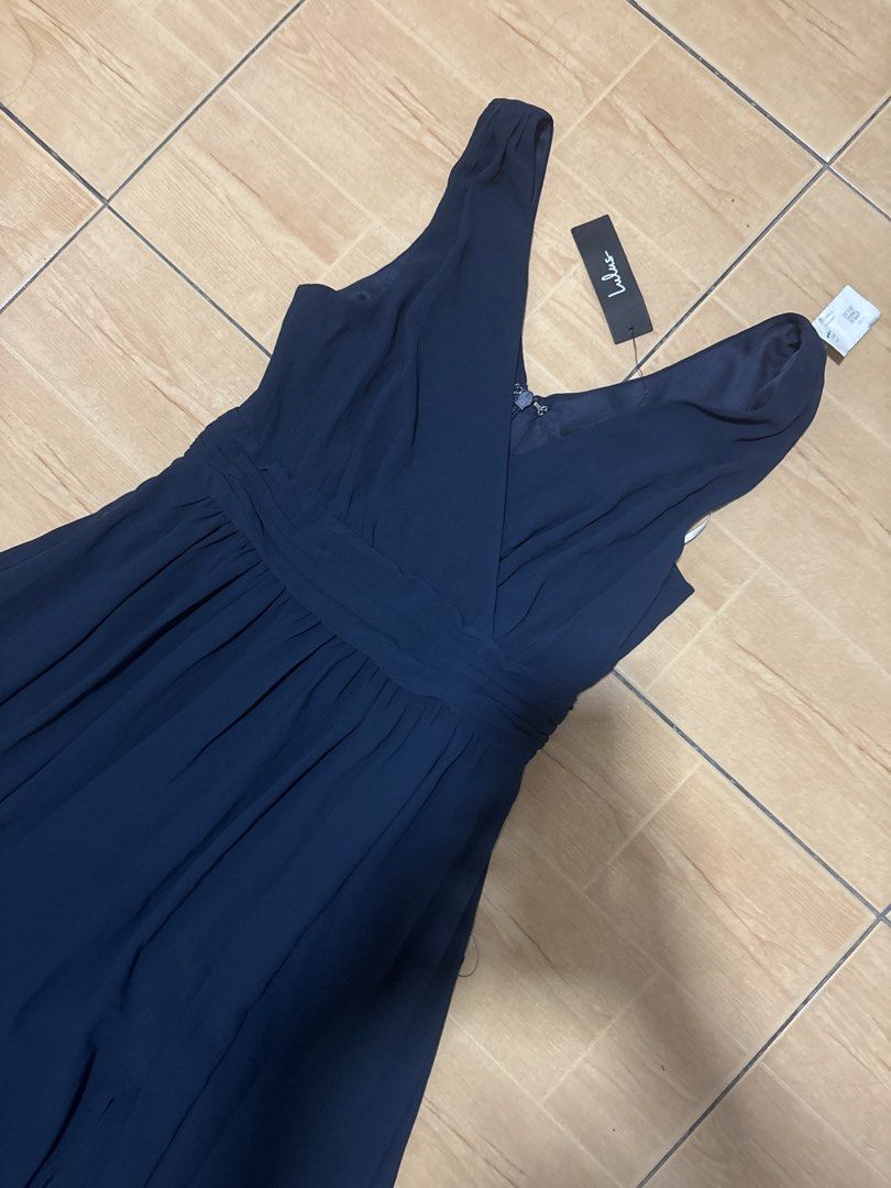 Lulus Navy Blue Maxi Dress Size M (Category: Evening dresses & gowns) located in Cabuyao City. Submitted by airpz (Listing ID 1470671167, Image 2). Description: - Brand: Lulus - Color: Navy Blue - Size: Medium (M) - Condition: Brand new with original store tags attached - Design: V-neckline, wrapped front bodice, ruched waist, and flowy chiffon skirt - Detail: Sexy thigh-high slit - Closure: Back zipper with hook and eye clasp - Ideal for formal 