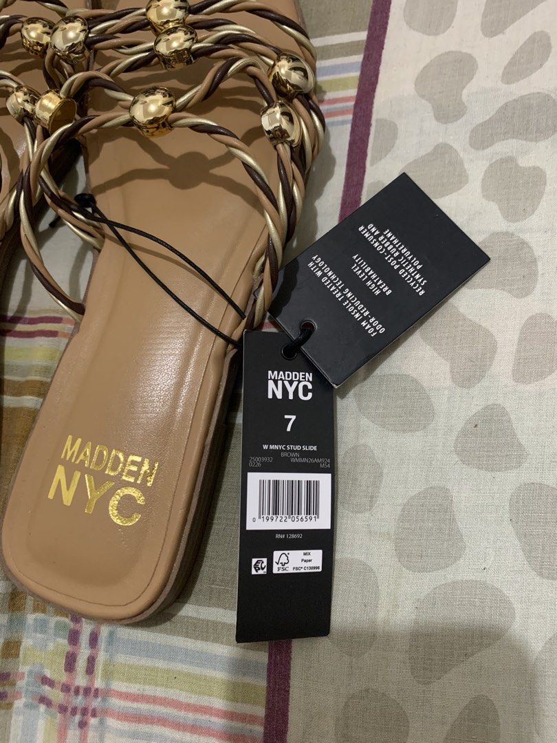 Madden NYC Stud Slide Sandals Brown Size 7 (Category: Flats & Sandals) located in Bugallon. Submitted by lavenderlane (Listing ID 1470681252, Image 2). Description: - Brand: Madden NYC - Item: Stud slide sandals - Color: Brown and metallic gold with gold-colored sphere accents - Size: US 7, EUR 38, MEX 24 - Design: Stylish braided strap - Comfort: Comfort foam performance insoles with odor-reducing technology - Condition: Brand new with original 