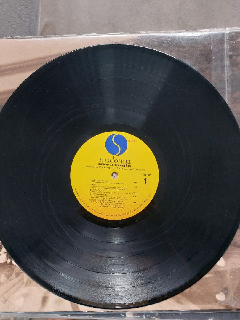 Madonna Like a Virgin Vinyl Record LP (Category: Vinyls) located in Quezon City. Submitted by safefish_95f205 (Listing ID 1470570936, Image 2). Description: - Artist/Album: Madonna - Like a Virgin - Label: Yellow Sire label (Side One) - Key Tracks: Material Girl, Like a Virgin - Condition: Record plays fine with clean grooves - Inclusions: Original outer sleeve with iconic cover portrait - Ideal for: Pop music collectors and 80s fans.