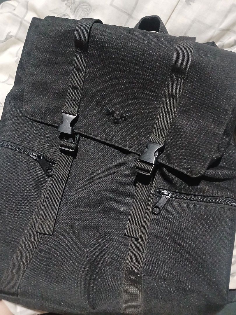 maH siro bag, the broken part can be replaced. (Category: Backpacks) located in Manila. Submitted by iiselou (Listing ID 1470674571, Image 1). Description: - Color: Sleek black - Material: Durable, sturdy canvas suitable for daily use - Design: Minimalist style with subtle embossed branding - Storage: Main zippered compartment plus extra zippered pockets - Closure: Dual front straps with secure plastic side-release buckles - Best for: School, wor