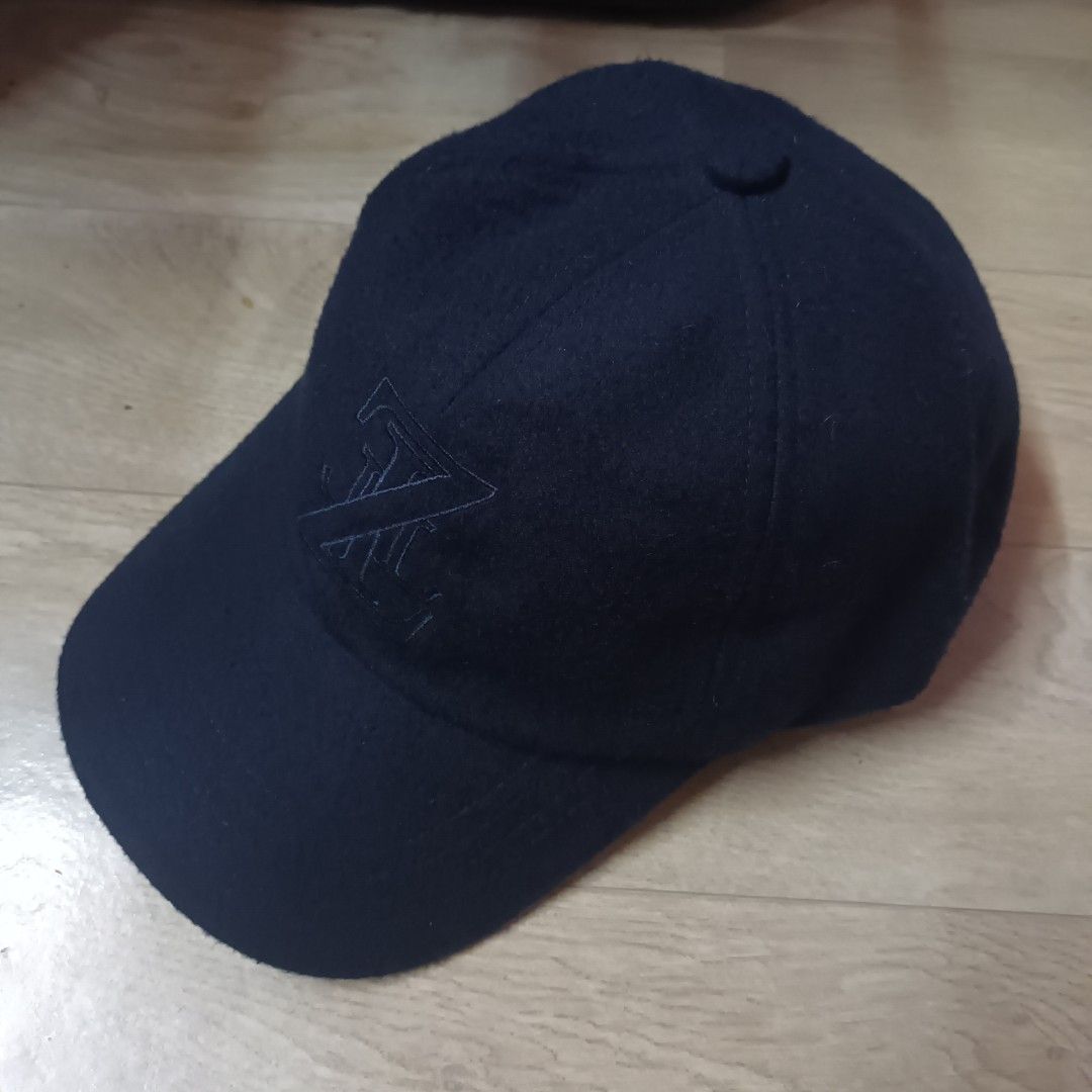 Maison Zilli Wool Cap (Category: Caps & Hats) located in Manila. Submitted by itsnik444 (Listing ID 1470636651, Image 3). Description: - Brand: Zilli - Color: Dark Blue - Design: Tonal embroidered monogram logo on front - Interior: Branded fabric lining with repeating Zilli logo - Structure: Structured crown with curved brim - Condition: Clean, well-maintained, excellent overall condition.