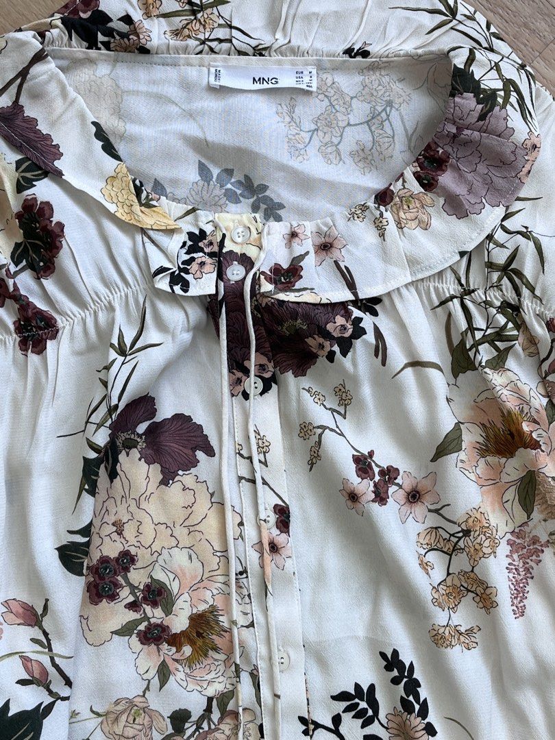 Mango Floral Top (Category: Blouses) located in Paranaque City. Submitted by PrelovedClosetetc (Listing ID 1470567357, Image 3). Description: Size M fits up to L Flowy fabric, Floral print, Baby doll neck, Long puffed sleeves, Bow fastening on the neck. 100% viscose.