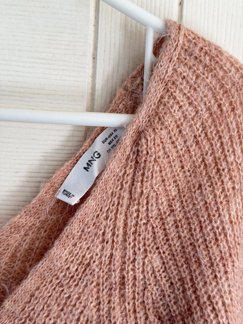 Mango Peach Pink Wool Knit Sweater (Category: Coats, Jackets and Outerwear) located in Manila. Submitted by cinnmoroll (Listing ID 1470597308, Image 2). Description: - Brand: Mango - Style: Wool knit sweater with wide V-neckline - Color: Lovely peach pink - Size: Tagged XL (fits standard oversized or regular) - Material: Cozy textured knit - Origin: Made in Turkey - Condition: Clean, well-maintained staple piece for cooler weather.