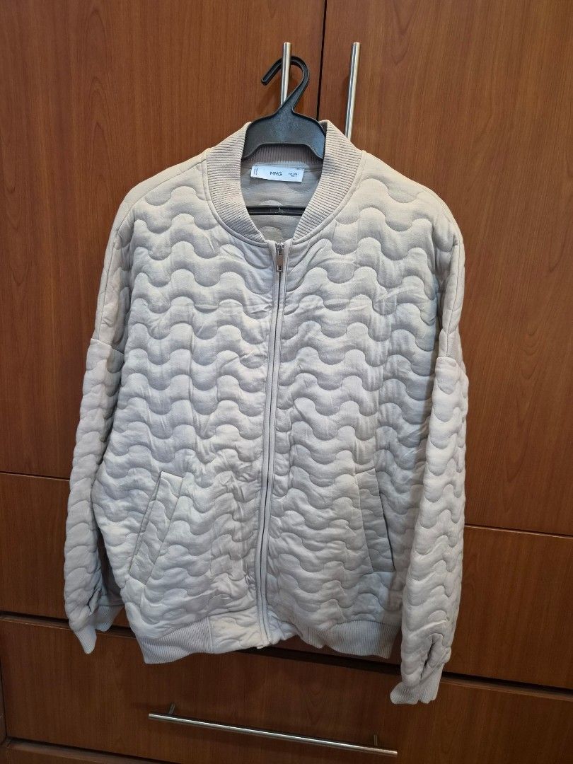 Mango Quilted Bomber Jacket Beige (Category: Coats, Jackets and Outerwear) located in Manila. Submitted by anythingbyjen (Listing ID 1470684885, Image 1). Description: - Brand: MNG - Size: Large - Color: Classic beige - Design: All-over quilted wave pattern with zip-up front - Features: Ribbed collar, cuffs, and hem, plus functional side pockets - Condition/Vibe: Comfortable fit, perfect warm layer for daily outfits.