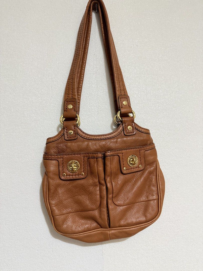 Marc Jacobs Leather Pocket Tote Bag (Category: Tote Bags) located in Dasmarinas. Submitted by elizmaebau68309 (Listing ID 1470678360, Image 1). Description: Tan Leather Multi-Pocket Tote Bag Designed in the mid 2000’s, this Marc by Marc Jacobs Multi-Pocket tote bag is crafted in tan leather with dual shoulder straps and twin turnlock front pockets. Fabric-lined interior with a zip pocket. Negotiable price. With visible stain in the pocket Very go