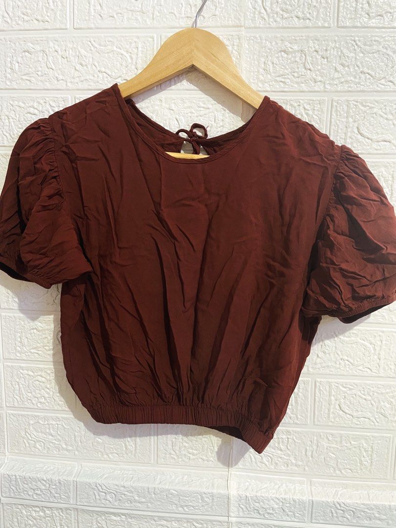 Maroon puff sleeve crop top with tie back (Category: Blouses) located in Manila. Submitted by myshanshine (Listing ID 1470570340, Image 1). Description: - Color: Maroon - Style: Crop top with short puff sleeves and round neckline - Details: Gathered elastic hem for a snug fit, cute back cut-out with tie string closure - Fabric: Soft and textured - Condition: Worn a couple of times, great shape - Styling: Perfect with high-waisted jeans or skirts.