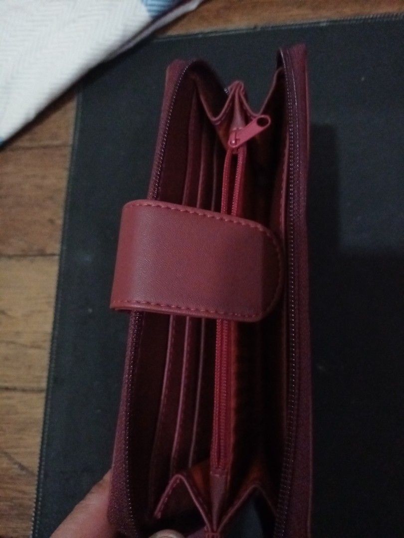 Martin Paris Maroon Long Zip Wallet (Category: Wallets & Card holders) located in Manila. Submitted by luckyeagle-7ff8 (Listing ID 1470590200, Image 3). Description: - Color: Maroon with elegant gold-tone hardware - Closures: Secure front flap with snap button and zippered coin pocket - Storage: Multiple card slots and spacious bill compartments - Interior: Clean lining featuring a stylish striped pattern in cash pockets - Size: Perfect dimension