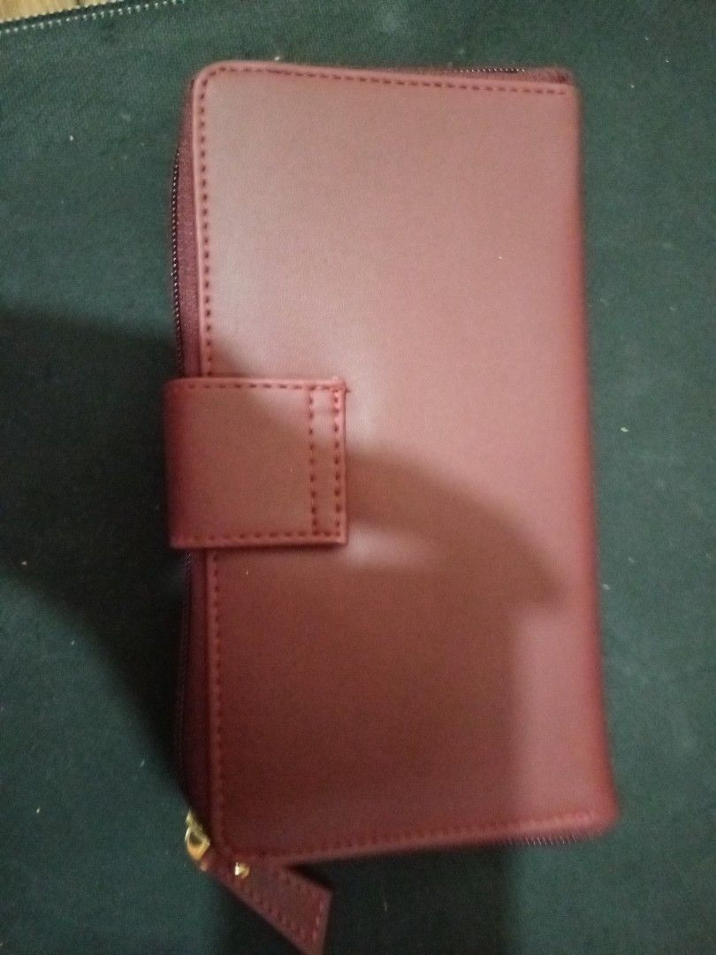 Martin Paris Maroon Long Zip Wallet (Category: Wallets & Card holders) located in Manila. Submitted by luckyeagle-7ff8 (Listing ID 1470590200, Image 2). Description: - Color: Maroon with elegant gold-tone hardware - Closures: Secure front flap with snap button and zippered coin pocket - Storage: Multiple card slots and spacious bill compartments - Interior: Clean lining featuring a stylish striped pattern in cash pockets - Size: Perfect dimension