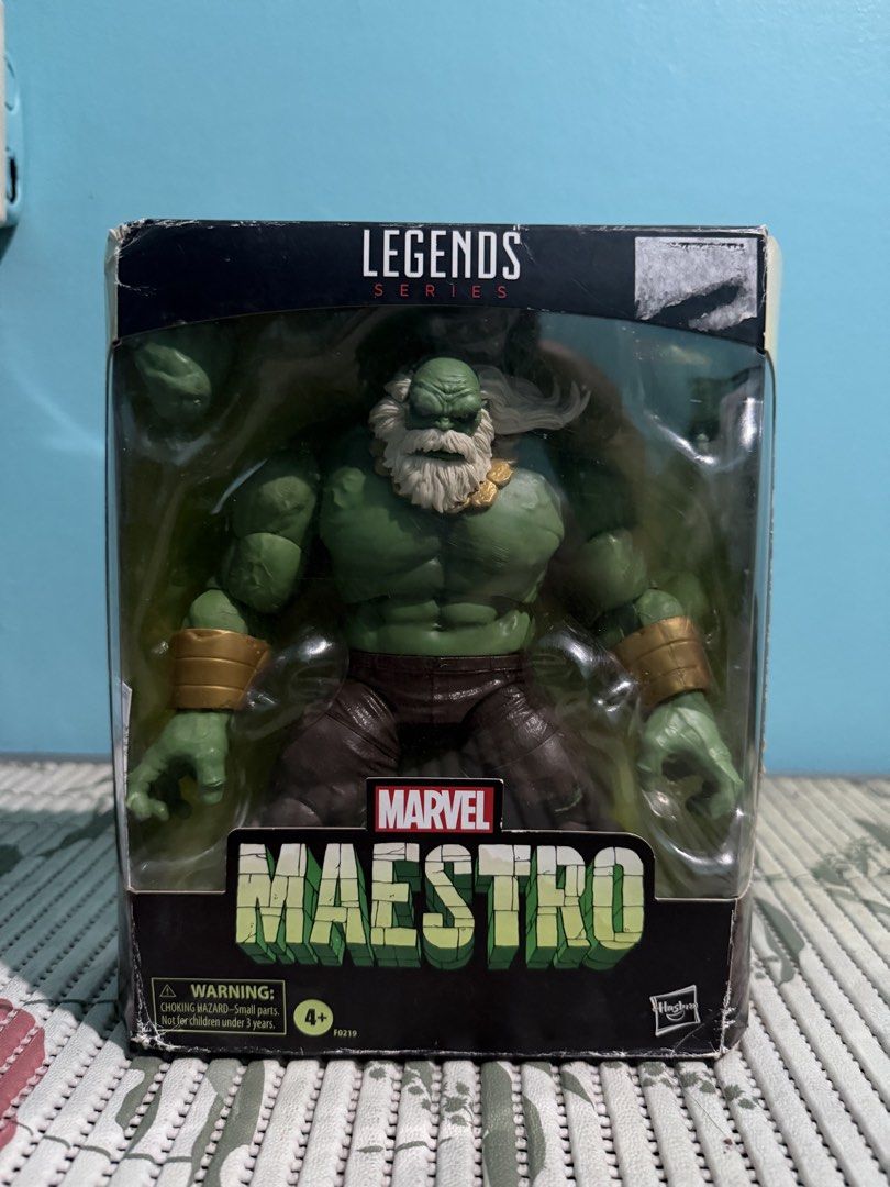 Marvel Legends Series Maestro Action Figure Hasbro (Category: Figurines & Statues) located in Cavite. Submitted by czymondegu04016 (Listing ID 1470687093, Image 1). Description: - Hasbro Marvel Legends Series Maestro action figure - Features green skin, white beard and hair, brown pants, and gold wrist cuffs - Includes alternate hands inside the clear window box - Packaging condition: Minor corner wear and a torn sticker mark at the top right edg