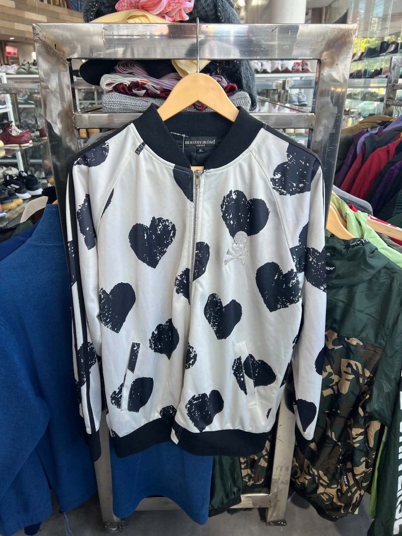 Mastermind Japan White Black Heart Bomber Jacket XL (Category: Coats, Jackets and Outerwear) located in Urdaneta. Submitted by jayceegarage (Listing ID 1470691754, Image 1). Description: - Brand: Mastermind Japan - Style: Zip-up bomber jacket - Color/Design: White base with all-over distressed black heart pattern - Details: Embroidered skull and crossbones logo on chest, functional side pockets - Trim: Ribbed black collar, cuffs, and hem - Materi