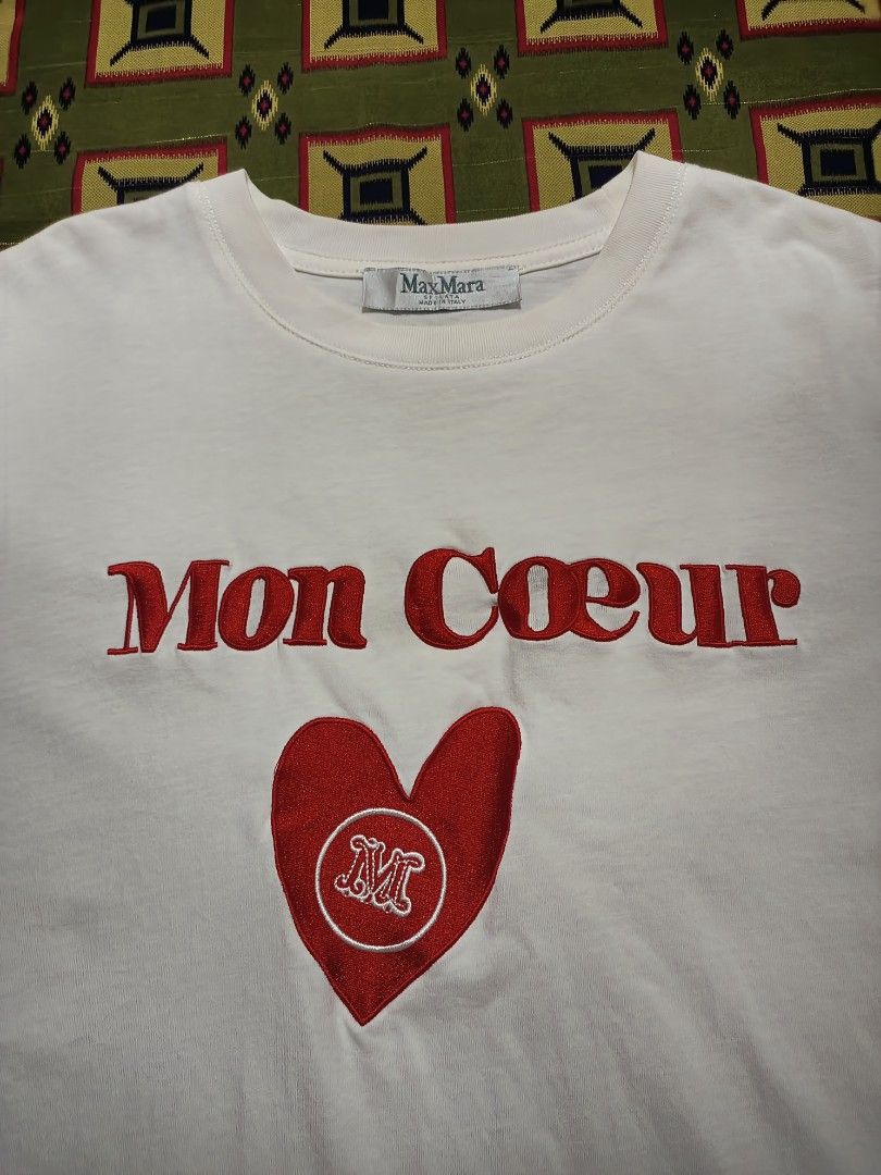 MaxMara Embroidered Mon Coeur White Tee (Category: Tshirts & Polo Shirts ) located in Lapu Lapu. Submitted by rebuild.arkives (Listing ID 1470621653, Image 2). Description: MaxMara Embroidered Mon Coeur White Tee ‎ ‎📏 Size Guide (Inches): ‎Length: 28 ‎Width: 20.5 ‎ ‎Color: 10/10 ‎Condition: 10/10 ‎Issue: None ‎ ‎📝 Heads up: ‎• This is a thrift item so please manage your expectations. ‎• Color may slightly differ due to lighting. ‎• Washed and r