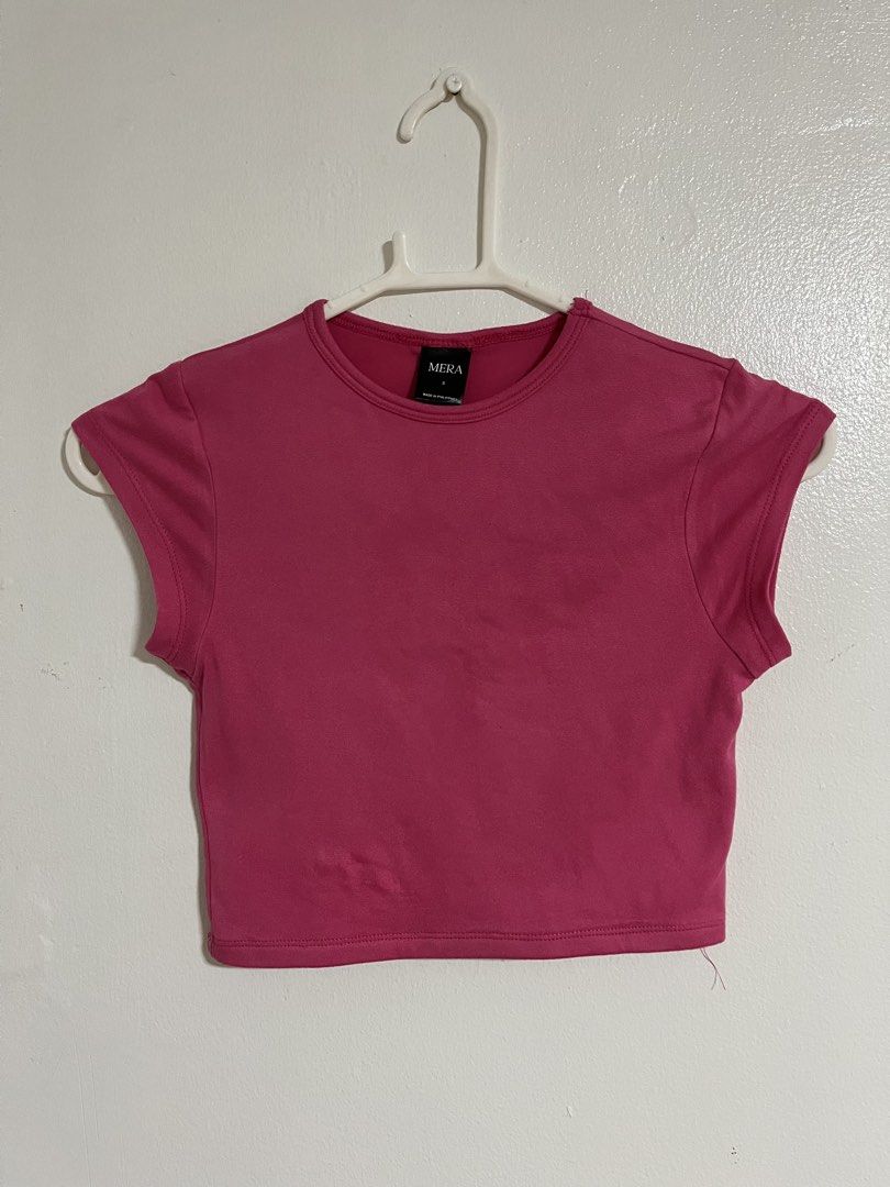MERA Pink Crop Top (Category: Shirts) located in Cabuyao City. Submitted by rdtrmt (Listing ID 1470743288, Image 1). Description: - Brand: MERA - Size: Small (tag at inner collar) - Color: Bright pink / solid - Style: Short sleeves, crew neckline, plain back crop top - Pairing tip: Easy to match with high-waisted jeans or skirts - Condition: still in good condition.